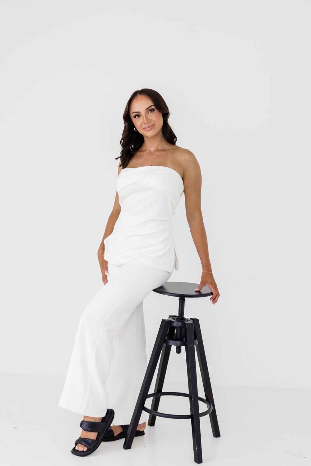Beauty educator seated on a stool