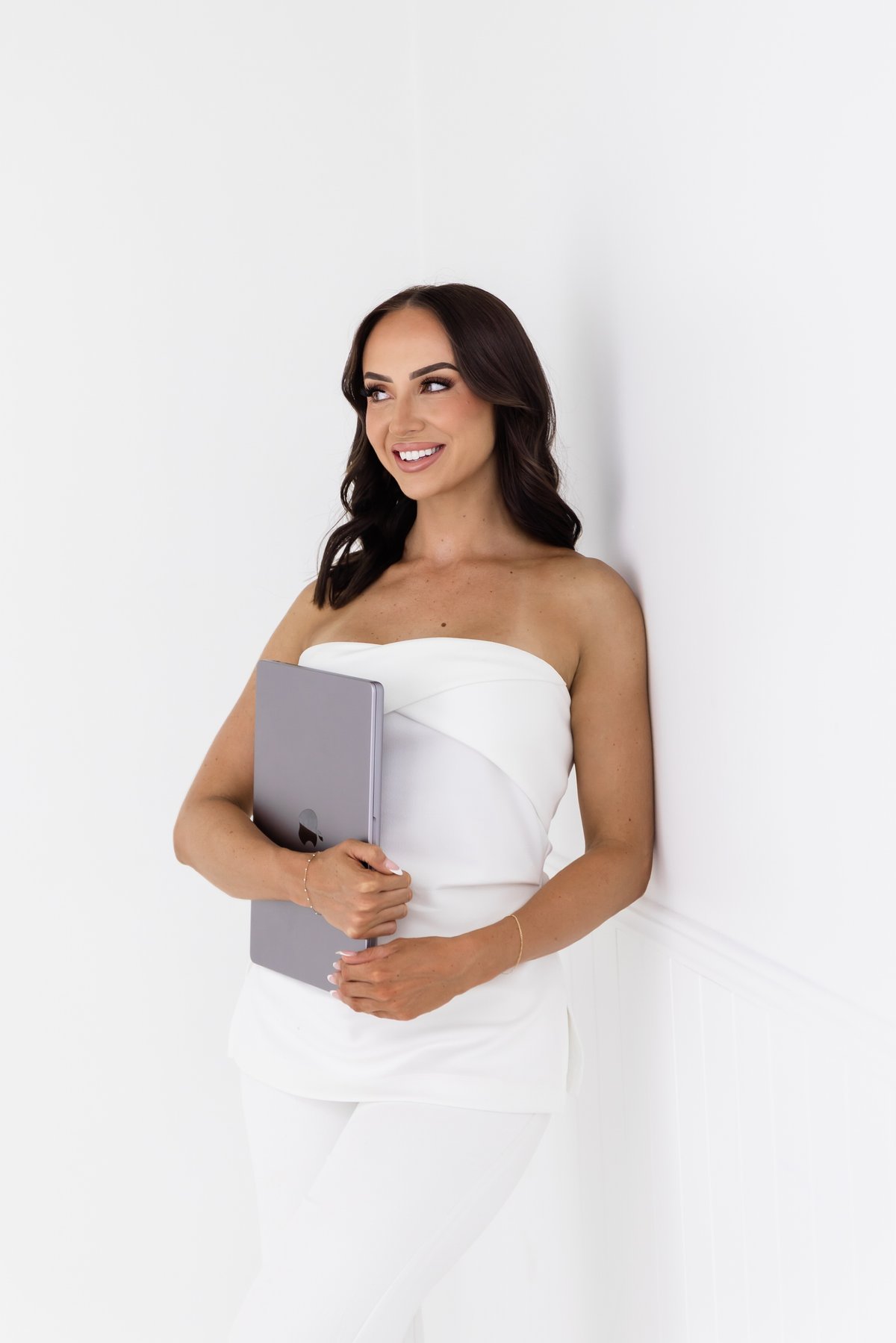 Beauty educator holding a laptop